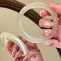 Close-up of translucent cat-eye stone bangle showing reflective luster and texture - Bangle / Single Piece / White