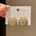 Close-up macro detail of vintage flower earrings with blue beads and gold tone finish - Round Floral Style (3#)