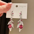 Close-up of vintage stainless steel drop earrings with red pear-shaped stones and zirconia. - Leaf Zirconia Style (5#)