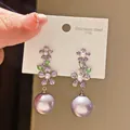 Detailed view of lavender purple pearl drop earrings with purple flower zircon accents. - Floral Large Pearl Style (15#)