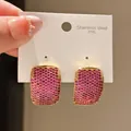 Macro detail of 316L stainless steel stud earrings pavé-set with vibrant pink zircon - Curved Rectangle Pavé Style (16#)