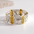 Detailed shot of retro gold and silver elastic bracelet with Love and Hope engravings - Gold-Silver