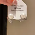 Exquisite detail of silver pearl stud earrings featuring sparkling baguette zircon accents - Pearl Pavé Curved Style (23#)