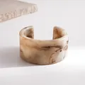 Close-up of retro marble texture resin open cuff bracelet in minimalist beige and brown - Beige
