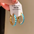 Close-up of gold-plated hoop earrings with turquoise beads and sparkling cubic zirconia - Gold Ring Turquoise Style (27#)