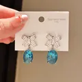 Elegant bow-knot earrings with sparkling blue oval crystal pendants and zirconia - Bow Oval Blue Stone Style (49#)