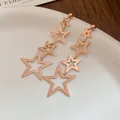 Minimalist rose gold stainless steel star drop earrings featuring a tiered star dangle design - Gold