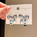Elegant stainless steel bow earrings featuring blue flower cubic zirconia accents - Bow Blue Small Flower Style (63#)