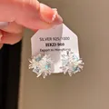 Vintage style silver-toned starburst stud earrings featuring light blue zircon stones - Blue Zirconia Radial Star Style (73#)