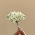 Detailed view of the delicate green and pink floral petals on a silver U-shaped hair pin - Single Piece (HH9871) / Green