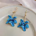 Detail of blue enamel flower earrings with elegant long golden branch-shaped stems - Gold-Blue