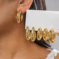 Close-up detail of 6-piece set gold C-shaped geometric hoop earrings with metallic finish - 6-Piece Set / Gold