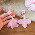 Detail view of pink resin flower earrings with delicate chiffon petal tassels - Pink