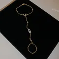 Detailed macro view of a gold-tone slave bracelet with sparkling zircon ovals. - Bracelet - Gold