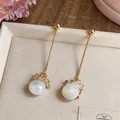 Elegant gold long tassel earrings featuring a white pearl and floral crystal detail - Silver Post Flower Style / Gold