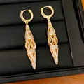 Detailed view of elegant gold-plated hollow rhombic drop earrings with paved stones - Gold
