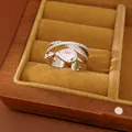 Detail of a multi-layer crisscross silver ring with a large pear-shaped zircon in a box. - Water Drop Ring
