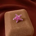 Elegant pink zircon starfish ear clip for non-pierced ears with a luxurious shine - Starfish Ear Clip / Silver Rose Red