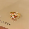 Detailed close-up of a 18k gold plated ring with a vibrant multi-color zircon flower design - Adjustable Open Ring (HR3466) / Gold-Multicolor