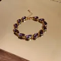 Detailed view of elegant purple water drop zircon bracelet with gold-plated finish - Bracelet - Gold / Purple
