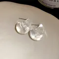Close-up macro view of clear acrylic water drop stud earrings with minimalist design. - Small Size / Clear