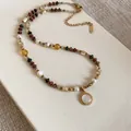 Detail of 18K gold plated beaded necklace with round pendant in bohemian style. - Bohemian Style (HN12678) / Multicolored (Gold Plated)