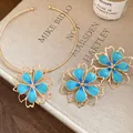 Exquisite detail shot of blue enamel hollow flower choker and stud earrings jewelry set - Choker And Stud Earrings (HN11587) / Blue