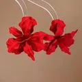 Detailed close-up view of vibrant red matte spray-painted flower statement earrings - Steel Pin Style / Red