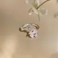 Close-up of a sweet zircon flower open ring featuring pink and clear petal-shaped stones - Silver-Pink