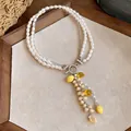 Detailed macro view of a double-strand pearl necklace with yellow lemon resin charms. - Silver-White-Yellow