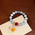 Elegante bracciale vintage in perle occhio di gatto con accenti azzurri e rossi - Bianco