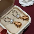 Detail view of vintage 18k gold plated drop earrings with pearl and amber stones in box. - Silver Post Style (HE34277) / Gold/Brown