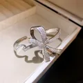 Elegant silver ribbon bow bangle encrusted with shimmering cubic zirconia stones - Silver