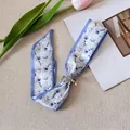 Elegant blue floral chiffon necktie scarf with a dainty silver bow brooch accessory. - Blue And White Floral