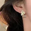 Korean style yellow enamel flower stud earrings with clear bead on female model - Silver Earring Post Style / Beige