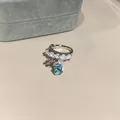 Elegant silver-toned ear cuff featuring blue square zircon and iris flower charm detail - Single Piece / Clip-On Earrings / Silver-Blue