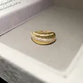 Macro detail of a 14k gold plated textured open ring with sparkling cubic zirconia stones. - Brushed Stripe Style / Gold