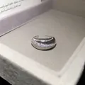 Close-up of silver plated open ring with sparkling zircons and ribbed texture. - Brushed Stripe Style / Silver