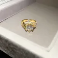 Close-up of 14k gold plated ring with a large round zircon and pavé setting details. - Large Main Stone Style / Gold