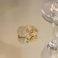 Close-up of a gold-plated eight-pointed star and moon ring with sparkling zircon stones - Open Adjustable Style / Gold