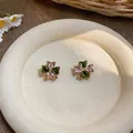 Detailed view of elegant four-leaf clover stud earrings featuring pink and green zircon stones - Silver Pin - Brown - Green