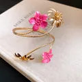Detailansicht der edlen goldfarbenen Oberarmspange mit rosa Emailleblüten und Dekor - Blumen-Oberarmreif (HB5828) / Gold mit Fuchsia