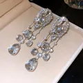 Élégantes boucles d'oreilles à longs pompons avec strass ovales et en forme de poire - Boucles d'oreilles à clip / Argent