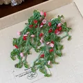 Close-up of forest-style green glass leaf earrings with pink flowers on silver needles. - Forest Tassel Style / Green-Pink-Red