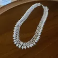 Detailed view of handmade pearl fringe necklace with intricate beadwork on wooden tray - Necklace Only (HN12661) / White