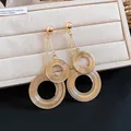 Detailed view showing the metallic texture of oversized multi-layer gold circular earrings - Silver Earring Post Style / Gold