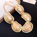 Detailed view of the gold-tone metal necklace with chunky irregular pleated plates - Necklace / Gold