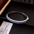 Detail view of a retro palace style silver bangle with blue and white cubic zirconia - Bangle (HB6076) / Silver-Blue