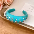 Detailed close-up view of teal resin cuff bracelet with silver metal rivet studs - Bangle / Cyan
