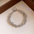 Detailed view of an elegant silver faceted beaded necklace with a secure lobster clasp - Silver